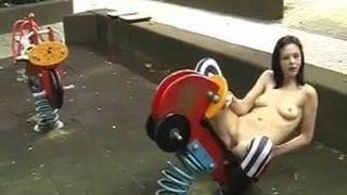 Goth girl naked on playground toys