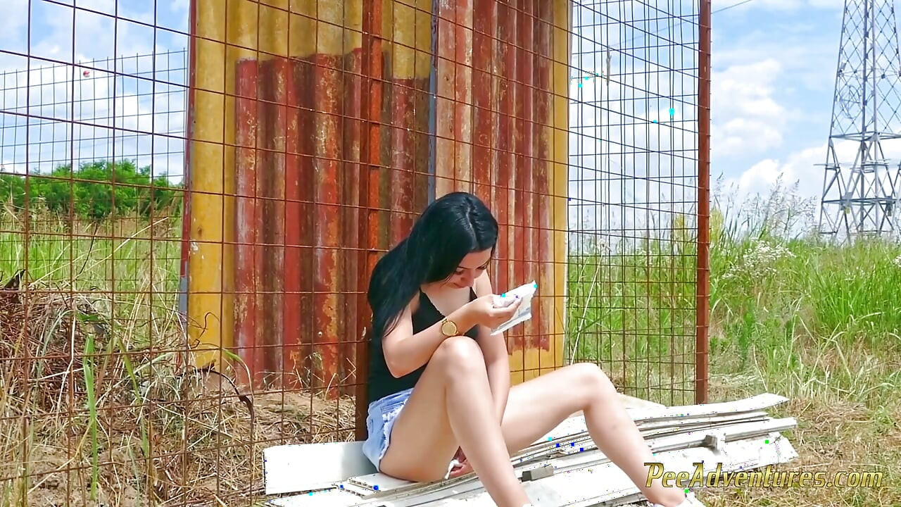 Sexy brunette quick pee next to a house in construction