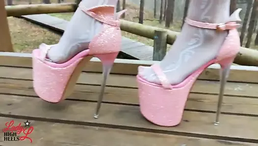 Lady L walking in towering pink extreme high heels.