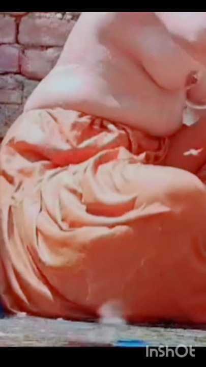 While bathing, the village woman is taking a bath naked after taking off her clothes completely | Clip 1