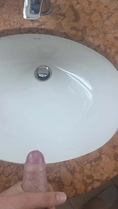 Secretly jerking off and cumming in the hotel bathroom while a friend can just walk in.