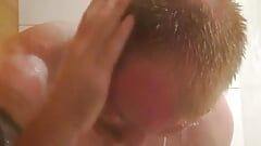 muscular guy is cleaning his body and take a shower