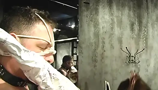 BDSM mistress in thigh-highs ropes dude's collared face and pulls his bound cock