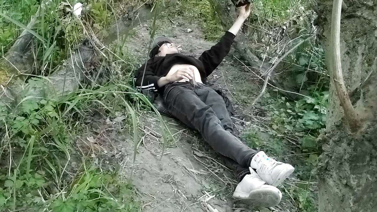 This gay twink sticks his cock through his fly to jerk off outside