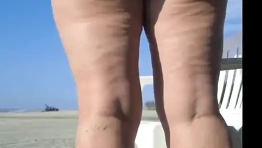 Hot crown sunbathing on the beach in transparent micro bikini