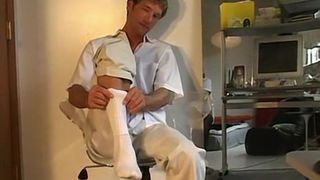 Gay feet wriggler takes socks off when masturbating solo