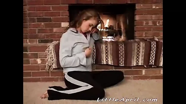 Little April with natural tits fingering beside fire place