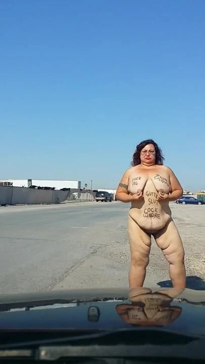 Slut outdoors with body writing