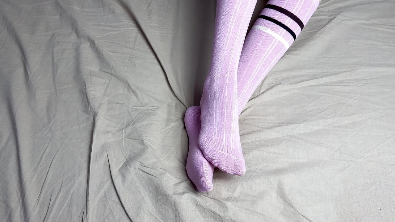 Pink socks in hands of mistress with blue nails in solo video
