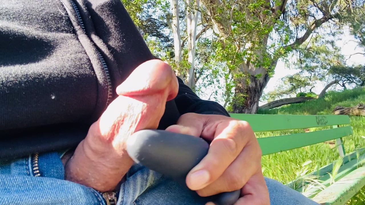 Cumshot with vibrator on the park bench