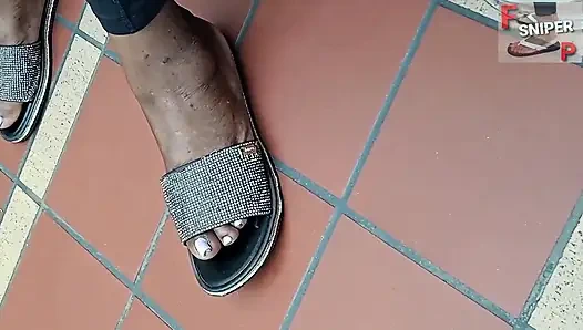 Работающая чернокожая дама с ступнями толстушки с розовыми пальцами ног