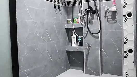 A Thai woman is taking a shower, revealing her pink nipples and smooth, soft vagina while applying body lotion.  Real Thai Solo
