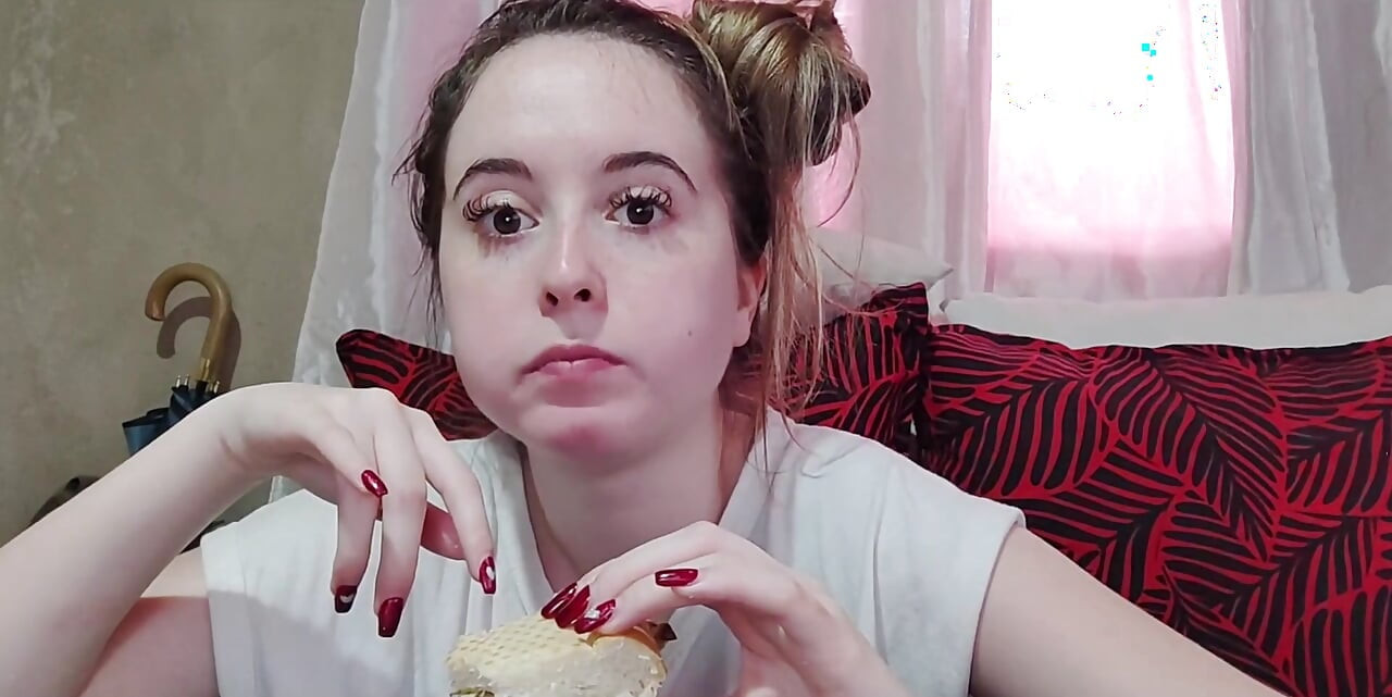 Eating an omelette sandwich with cherry tomatoes