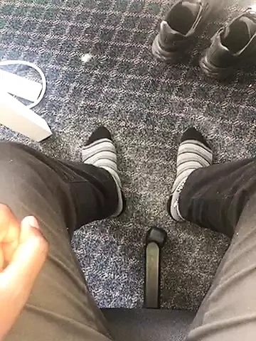 Young African feet out in socks in the office