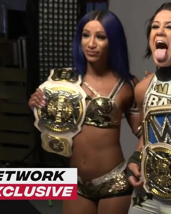 WWE - Sasha Banks and Bayley posing with the Tag Team titles