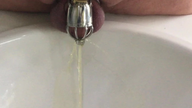 Pissing in my chastity cage