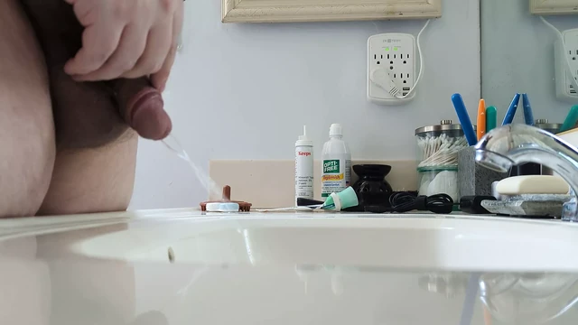 Cub Pissing in Bathroom Sink