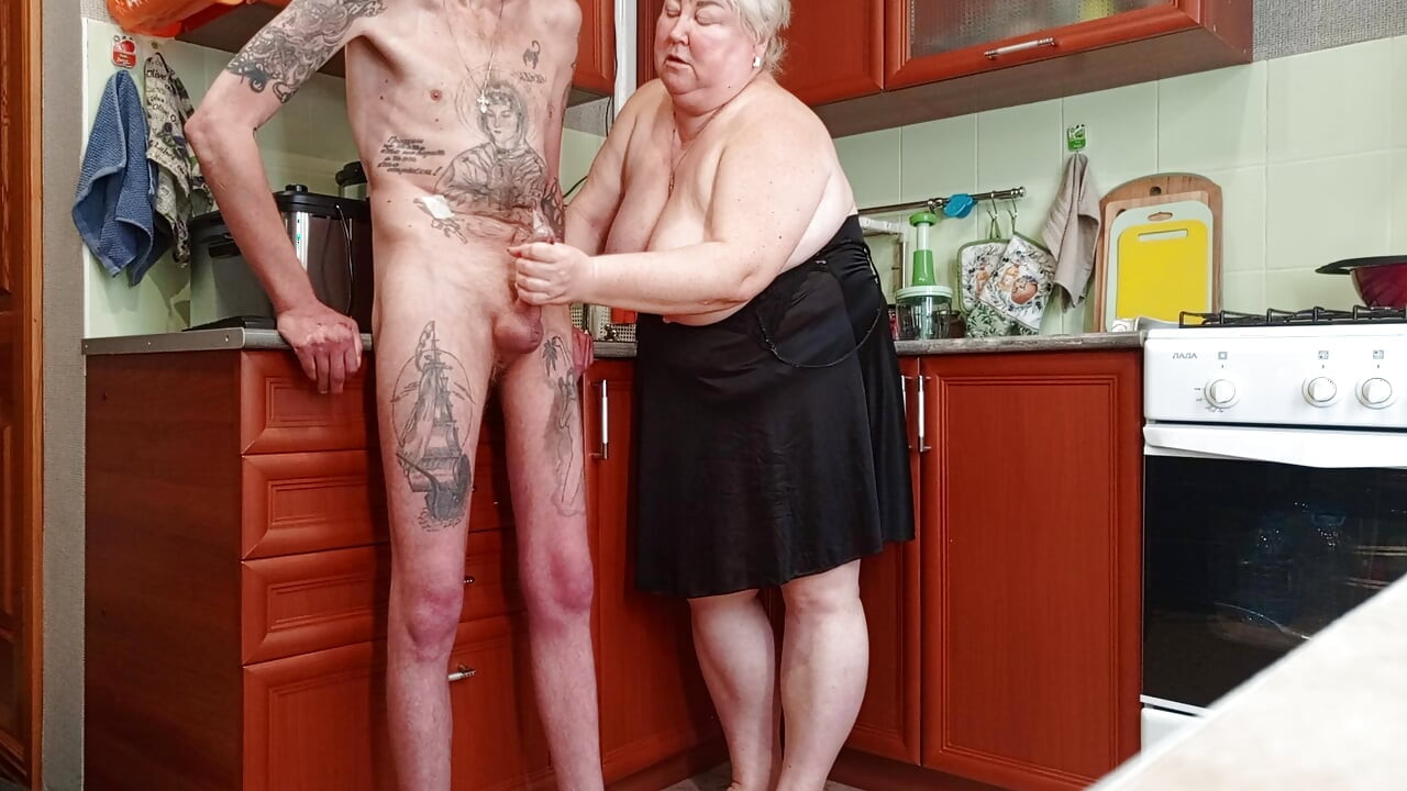 I came to the kitchen and flashed my cock to my stepmom and she jerks off and sucks it until I cum