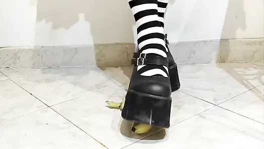 Goth crushing a banana under her shoes