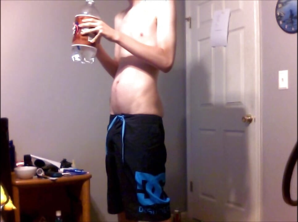 Young Guy Fills His Stomach with Water