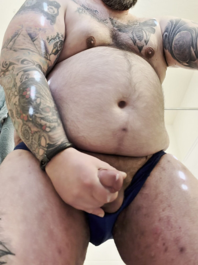 Knubbig hårig tatuerad björn som strök och kommer
