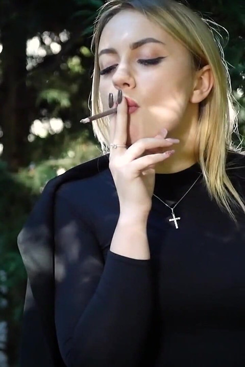 Hot Blonde Babe Smoking Two Black Cigarettes in Nature