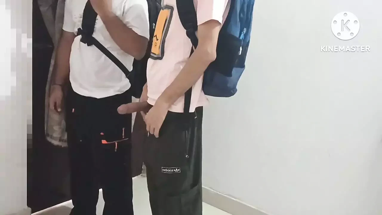 Two college students having gay fun in school library