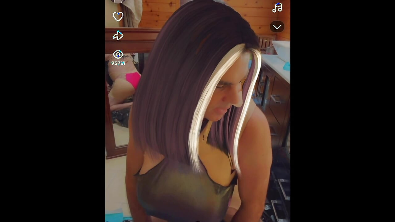 Sexy shemale wears shiny metallic halter top while masturbating