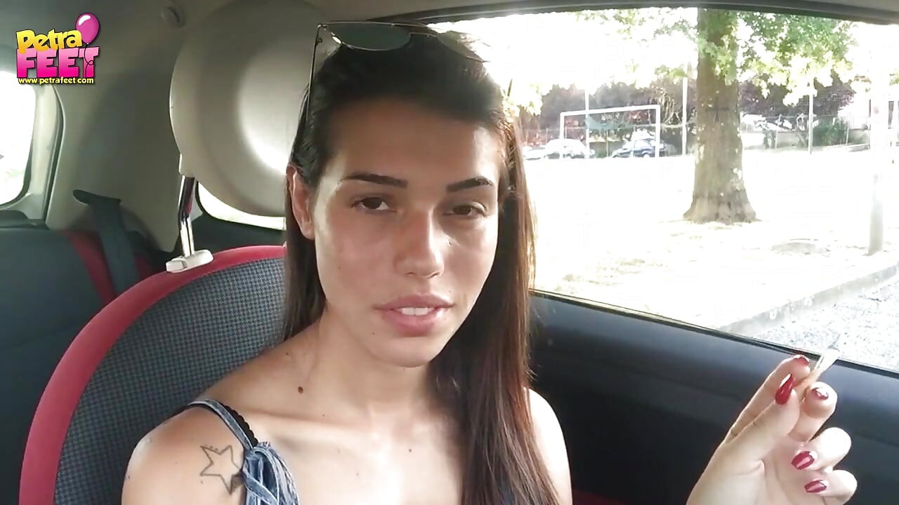 Cute teen Petra smoking in the car