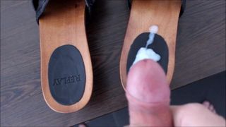 Cumming on black Replay Clogs before giving them away