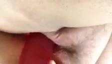 Laura stuffing a big red dildo in her wet pussy