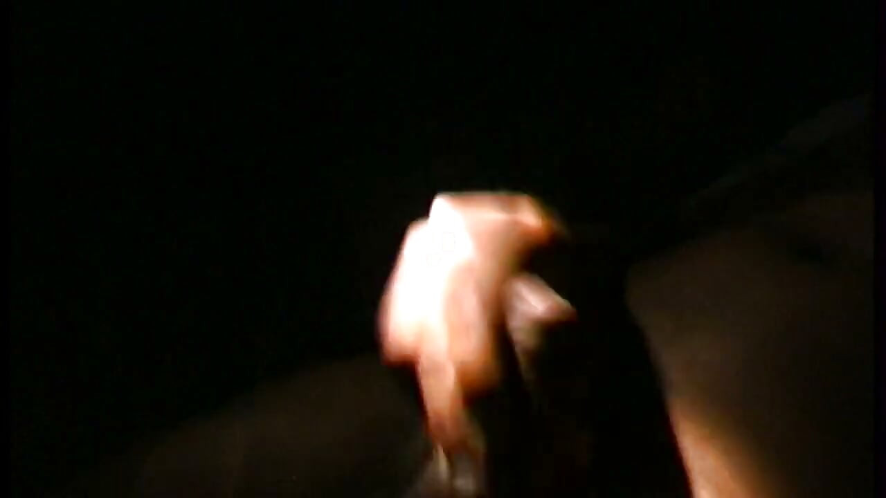 A black shemale sucks the cock of a masked man in the countryside