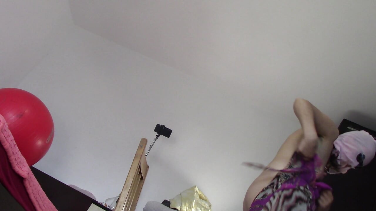 Amateur wife dancing naked at home. Amateur woman has fun trying on clothes and cutting them.