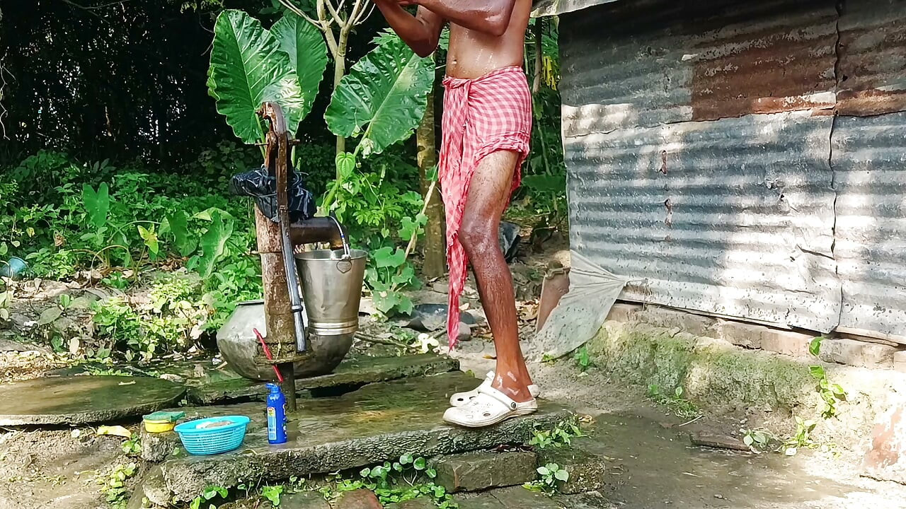 Desi young man bath Open place.