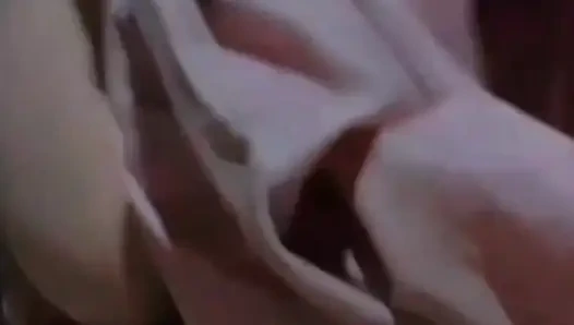 Alone in the house, a woman is calming her pussy with eggplant