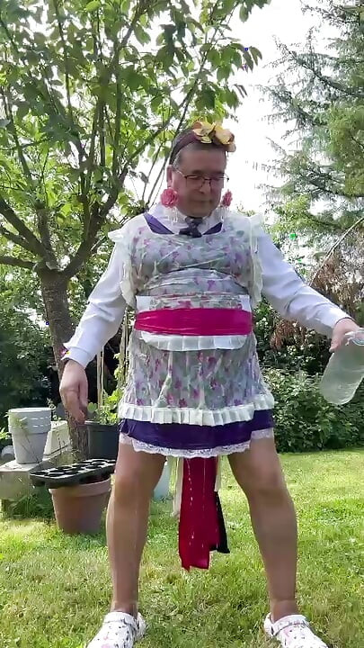 In gardener's clothes to take a piss shower outside fully dressed