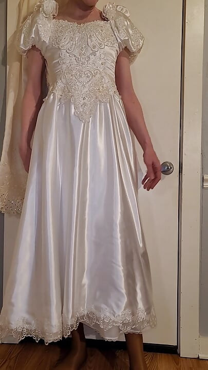 Trying on a liquid satin wedding dress.