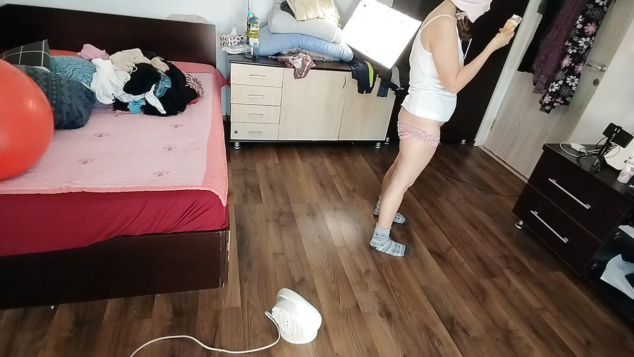 Amateur wife dancing naked at home. Amateur woman has fun trying on clothes and cutting them.