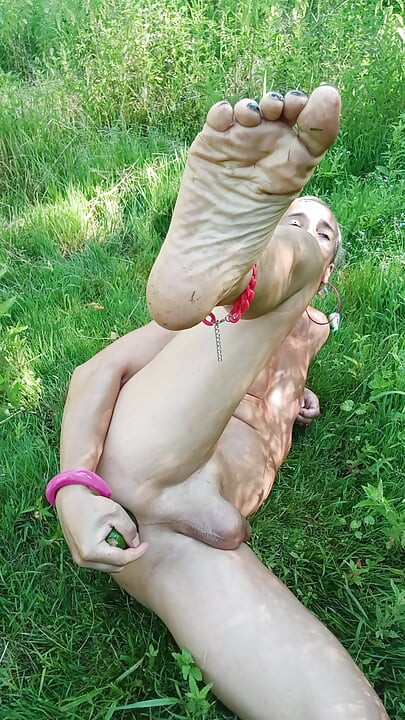 This dirty faggot, this naked sissy slut, is pleasuring her asshole with a huge cucumber, part 2.