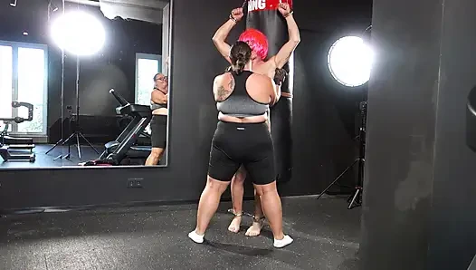 Mistress April practices boxing on a human punching bag.