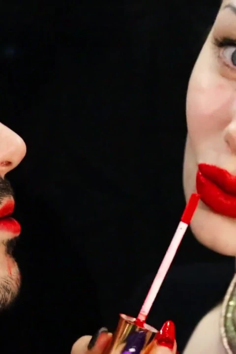 Covering Alex face with red lipsticks kisses