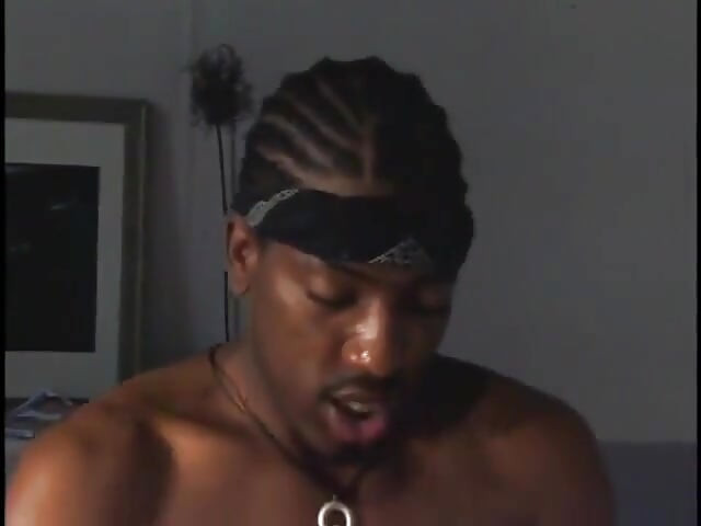 Black man lies on a chair with a boxer short on and gets a warm blowy