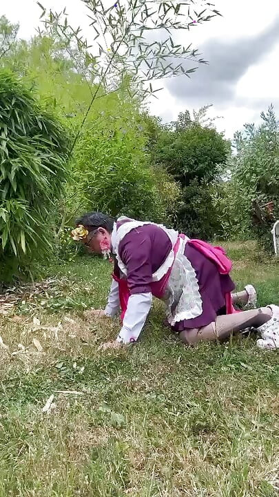 In gardener's outfit, peeing on all fours like a dog