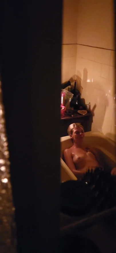 Captivating moment from "Peeping through my neighbours bathroom window,watch how she plays with her pussy"