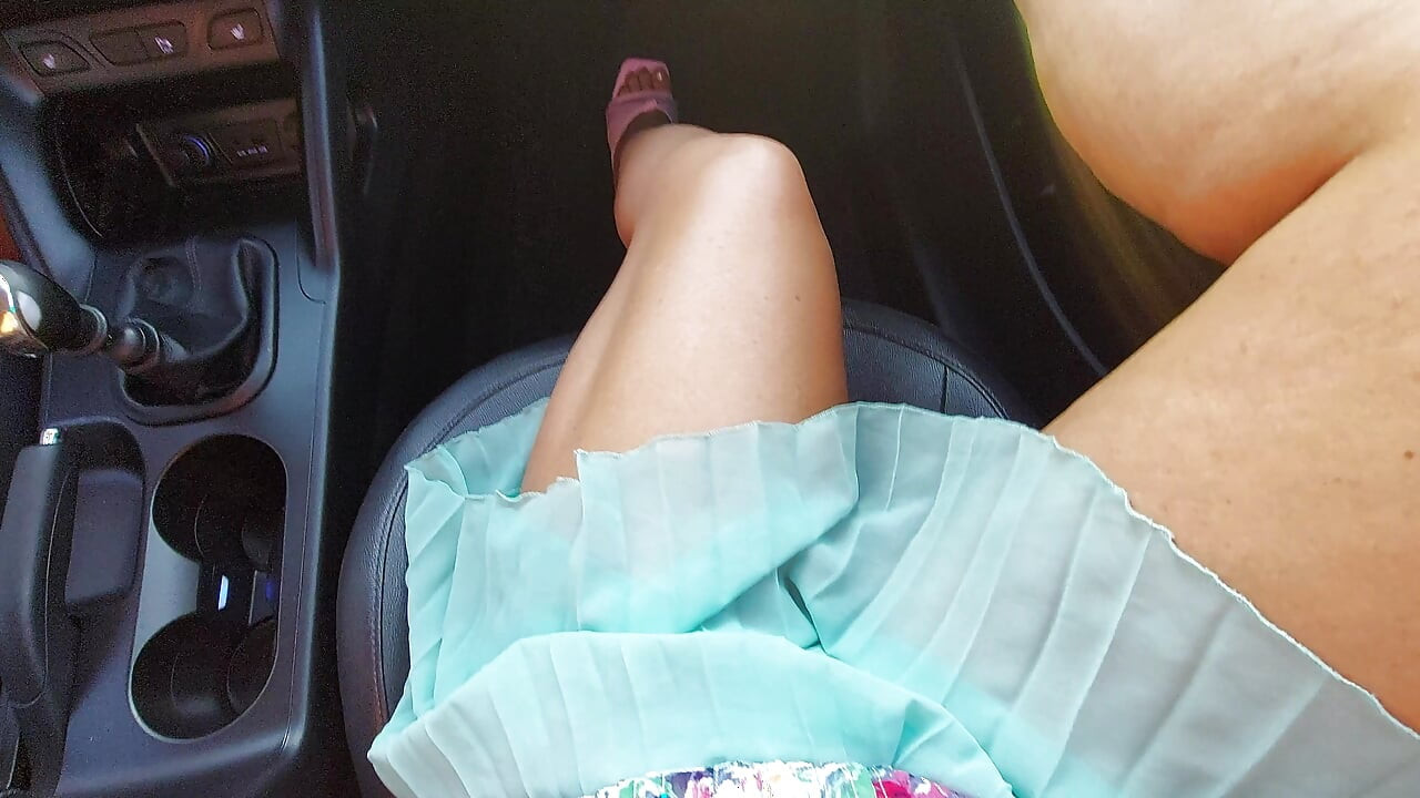 An attractive and elegant MILF with sexy legs in high heels and a short skirt, in a taxi, in the morning