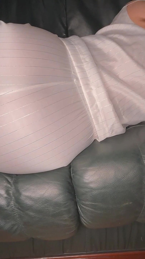 Farting in White Satin Pajama on Green Leather Sofa