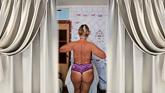 Hot housewife Lukerya flirts and changes clothes in the kitchen.