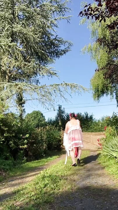 In an outfit with a pink nightgown and a white robe for an evening.