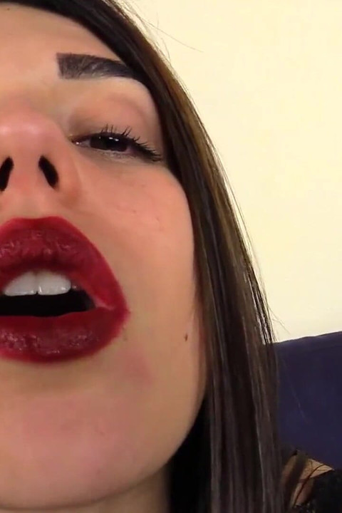 Beautiful Italian girl is smoking a cigar in close up