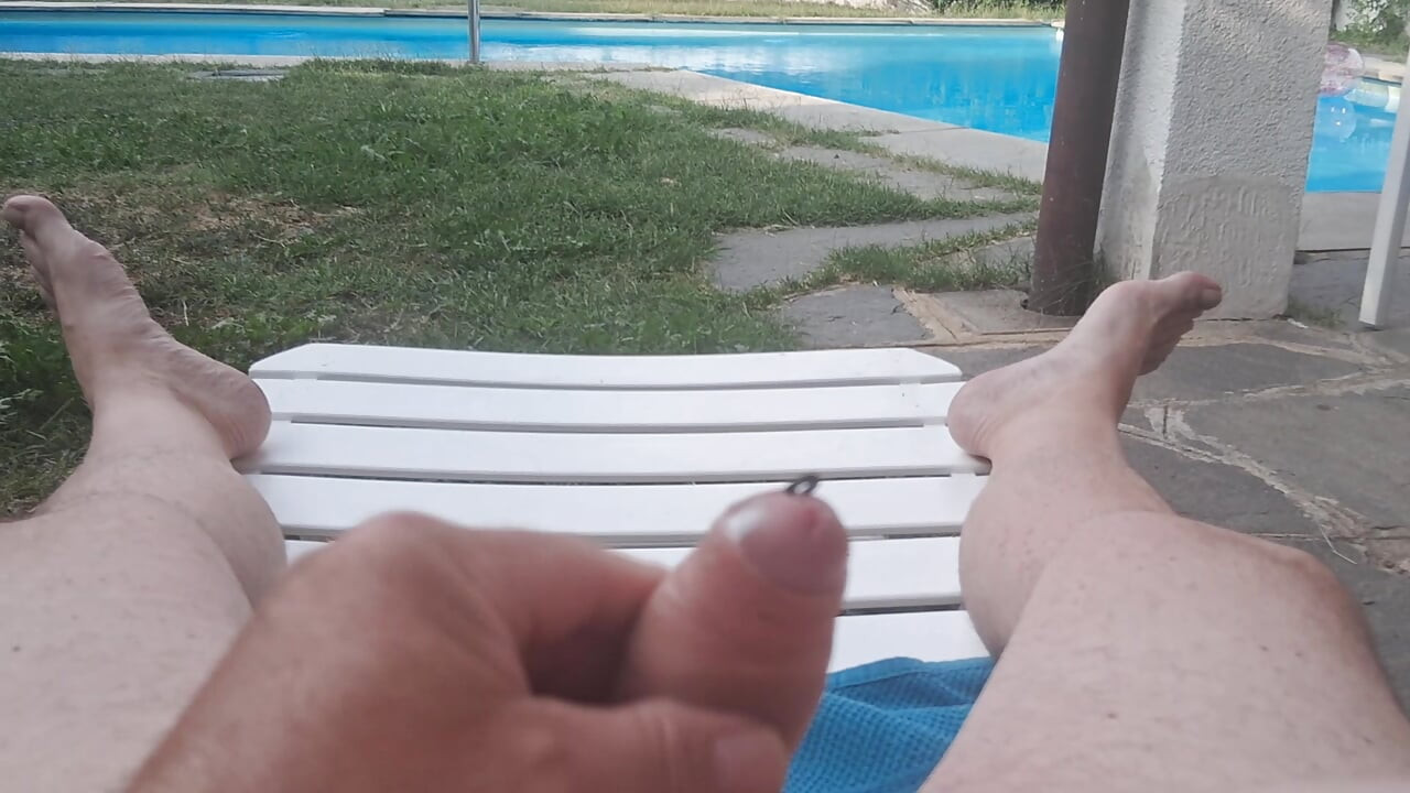 Penis massaging by the pool, with cumshot